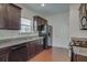 Modern kitchen with dark wood cabinets and granite counters at 5138 Mcever View Dr, Sugar Hill, GA 30518