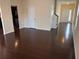 Open concept living room with hardwood floors and access to other rooms at 5138 Mcever View Dr, Sugar Hill, GA 30518