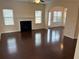 Spacious living room with hardwood floors, fireplace, and large windows at 5138 Mcever View Dr, Sugar Hill, GA 30518