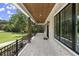 Covered porch with wooden ceiling, herringbone brick floor, and view of the backyard at 1645 Mayfield Rd, Alpharetta, GA 30009