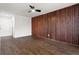 Spacious living room featuring hardwood floors, a ceiling fan, and a decorative wood accent wall at 1956 Gober Se Ave, Smyrna, GA 30080