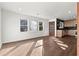Bright living room with hardwood floors and a view into a modern kitchen with stainless appliances at 1956 Gober Se Ave, Smyrna, GA 30080