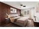 Comfortable bedroom with stylish accent wall, ceiling fan, and lots of natural light from a nearby window at 1956 Gober Se Ave, Smyrna, GA 30080