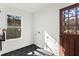 A bright mud room with black tile flooring, window and a wooden door to the backyard deck at 1956 Gober Se Ave, Smyrna, GA 30080