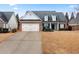 Brick and white two-story house with a two-car garage and landscaping at 23 Spring Folly Nw, Cartersville, GA 30121