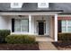 Covered porch with black front door and white columns at 23 Spring Folly Nw, Cartersville, GA 30121