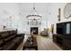 Living room featuring a fireplace, chandelier, and hardwood floors at 23 Spring Folly Nw, Cartersville, GA 30121