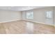 Unfinished basement with light hardwood floors, neutral walls, and bright light at 115 Hedgewood Ln, Canton, GA 30115