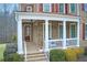 Inviting front porch with brick flooring, classic columns, and cozy seating, perfect for relaxing outdoors at 115 Hedgewood Ln, Canton, GA 30115