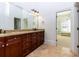 Bathroom boasting a large vanity with granite countertop and dark wood cabinets, combining style and functionality at 3340 Switchbark Ln, Alpharetta, GA 30022