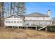 Back of house showing deck, sunroom addition, and wooded area at 4794 Deer Chase, Powder Springs, GA 30127