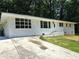 Charming white brick ranch house with a tree-lined street at 345 Forest Valley Rd, Lawrenceville, GA 30046