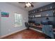 Home office with built-in shelving and hardwood floors at 6982 Springwood Dr, Douglasville, GA 30135