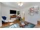 Bright living room with a TV, gallery wall, and hardwood floors at 974 Greenwood Ne Ave # 2, Atlanta, GA 30306