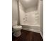 Bathroom with shower/tub combo and dark wood floor at 1635 River Main Ct, Lawrenceville, GA 30044