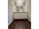 Bathroom with granite countertop and dark wood floor at 1635 River Main Ct, Lawrenceville, GA 30044