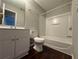 Clean bathroom with a shower/tub combo and white vanity at 1635 River Main Ct, Lawrenceville, GA 30044