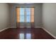 Bedroom with hardwood floors and window with orange curtains at 1635 River Main Ct, Lawrenceville, GA 30044