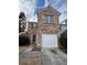 Brick townhouse with attached garage and landscaping at 1635 River Main Ct, Lawrenceville, GA 30044