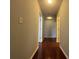 Long hallway with hardwood floors and access to bedrooms at 1635 River Main Ct, Lawrenceville, GA 30044