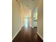 Long hallway with dark wood floors leading to living area at 1635 River Main Ct, Lawrenceville, GA 30044