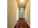 Clean hallway with hardwood floors and access to bedrooms at 1635 River Main Ct, Lawrenceville, GA 30044