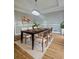 Dining room with hardwood floors, a modern table, and six chairs at 295 Creekview Trl, Fayetteville, GA 30214