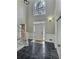 Two-story foyer with dark marble flooring, a white door, and a staircase at 295 Creekview Trl, Fayetteville, GA 30214