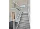 Elegant staircase with white railings and gray carpeting at 295 Creekview Trl, Fayetteville, GA 30214