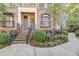 Brick townhouse with steps, wrought iron railings, and landscaping at 3633 Habersham Rd, Atlanta, GA 30305