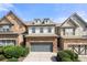 Brick front townhouse with gray garage door and landscaping at 5649 Cobblestone Creek Pl # 13, Mableton, GA 30126