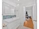 Modern bathroom vanity with a stylish blue backsplash and an entryway to the bedroom at 1075 Peachtree Ne Walk # A421, Atlanta, GA 30309