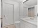 Bright bathroom with a sink, toilet, and door to the shower/tub area at 1075 Peachtree Ne Walk # A421, Atlanta, GA 30309