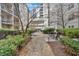 Outdoor courtyard with tables, chairs and manicured hedges provide a serene and relaxing area for residents at 1075 Peachtree Ne Walk # A421, Atlanta, GA 30309