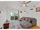 Bright living room featuring a gray sectional sofa, modern ceiling fan, and balcony access with city views at 1075 Peachtree Ne Walk # A421, Atlanta, GA 30309