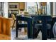 Modern glass dining table with dark velvet chairs sits in a bright, spacious kitchen at 2505 Astaire Nw Ct, Atlanta, GA 30318