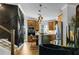 Well-lit kitchen with modern appliances, a breakfast bar, and decorative lighting fixtures adjacent to staircase at 2505 Astaire Nw Ct, Atlanta, GA 30318