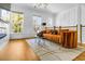 Sunlit living room with wood floors, large windows, and a stylish orange sofa at 2505 Astaire Nw Ct, Atlanta, GA 30318