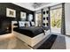 Modern bedroom with black walls and a white platform bed at 2505 Astaire Nw Ct, Atlanta, GA 30318