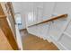 Elegant staircase with wood railing and white wall paneling at 2505 Astaire Nw Ct, Atlanta, GA 30318