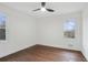 This bright bedroom features hardwood floors, two windows for natural light, and a ceiling fan at 2724 Larkspur Se Dr, Atlanta, GA 30316