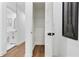 Hallway with wood floors, a linen closet, and glimpses of a stylish bathroom at 2724 Larkspur Se Dr, Atlanta, GA 30316