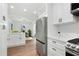 Contemporary kitchen showcases stainless steel appliances, white cabinetry, and hardwood floors at 2724 Larkspur Se Dr, Atlanta, GA 30316