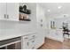 Bright kitchen boasts white cabinetry, modern appliances, and stylish shelves with decorative items at 2724 Larkspur Se Dr, Atlanta, GA 30316