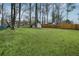 Expansive backyard featuring a storage shed, fence line, a pool, and beautiful trees offering ample outdoor space at 4488 Richard Rd, Conley, GA 30288