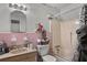 Bathroom featuring pink tile, a shower and tub, and a vanity with a sink at 4488 Richard Rd, Conley, GA 30288