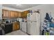 This kitchen features oak cabinets, black appliances, and black and white tile backsplash at 4488 Richard Rd, Conley, GA 30288