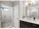 Bright bathroom with walk-in shower, vanity, and marble tile at 613 Stone Field Nw Run, Marietta, GA 30060