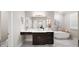 Modern bathroom with a floating vanity, free standing tub, and marble floors at 613 Stone Field Nw Run, Marietta, GA 30060