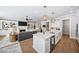 Open kitchen with large island, white cabinets, and stainless steel appliances at 613 Stone Field Nw Run, Marietta, GA 30060